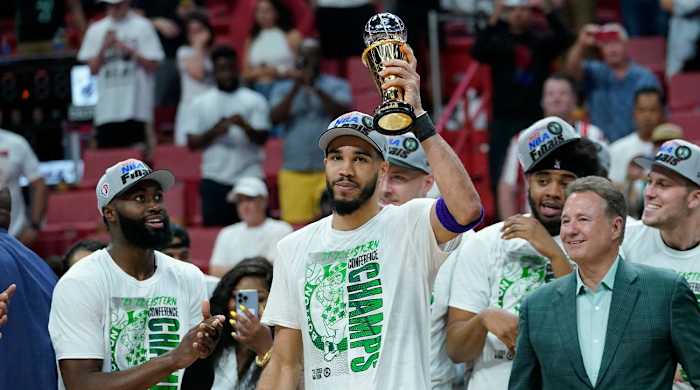 Boston Celtics forward Jayson Tatum raises the NBA Eastern Conference MVP trophy after defeating the Miami Heat in Game 7 of the NBA basketball Eastern Conference finals playoff series, Sunday, May 29, 2022, in Miami.